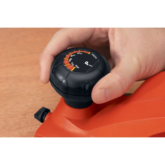 BLACKDECKER 7698K adjustment knob close-up, hand adjusting orange power tool.