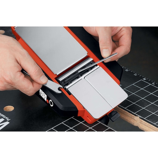 Photo of BLACKDECKER 7698K jointer-planer from above with hands adjusting blade using wrench and tool.
