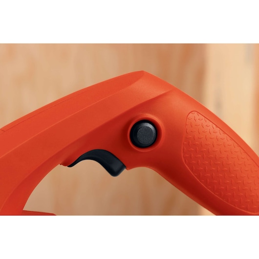 Close-up of BLACKDECKER 7698K power tool handle with textured orange grip and black on/off button, side angle.