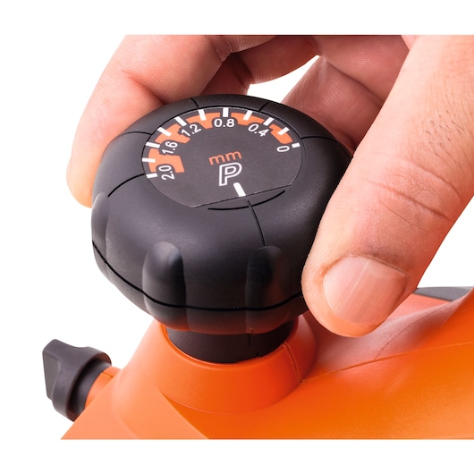 BLACKDECKER knob with millimeter gauge, SKU 7698, photography of orange tool detail, close-up angle.