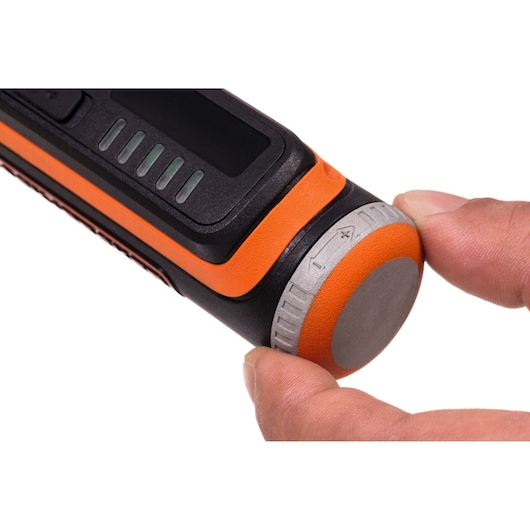 BLACKDECKER BCRT8K35 close-up of orange and black tool handle with silver adjustment knob held by fingers.