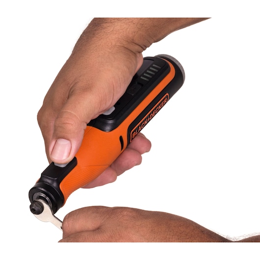 Photo of BLACK+DECKER BCRT8K35 orange cordless rotary tool in hand, close-up showing front side.