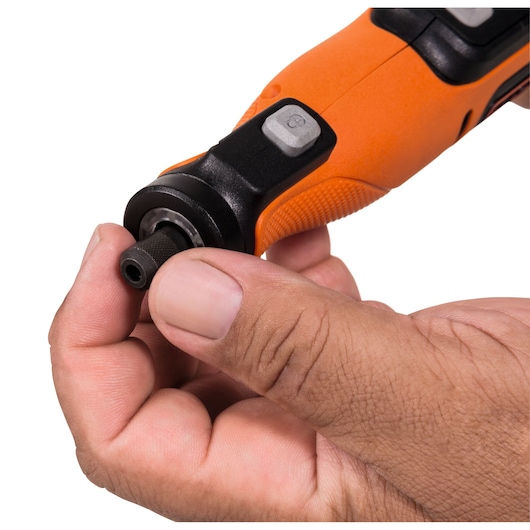 Close-up photo of BLACKDECKER BCRT8K35 rotary tool with textured orange grip, held in hand, white background.