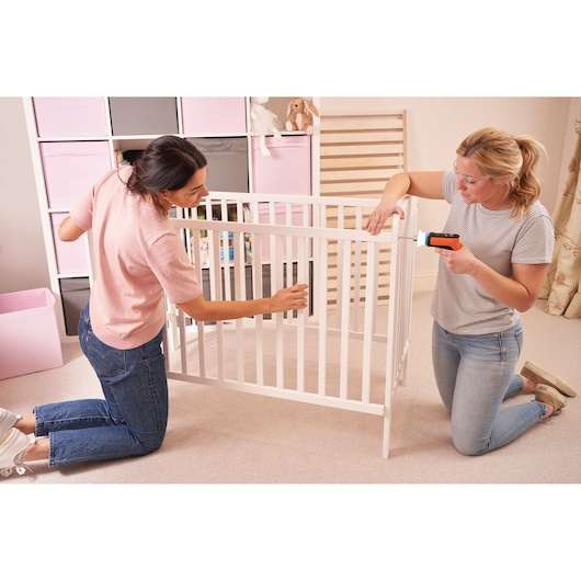 Photo of BLACKDECKER BCRTA601I cordless screwdriver used to assemble a white crib in a nursery.