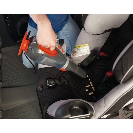 BLACKDECKER BDCV610-LA handheld vacuum cleaner used to clean cereal from car seat.