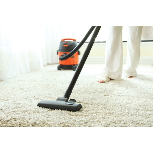 BLACKDECKER BDWD10 wet and dry vacuum cleaner in use on light carpet, product photography