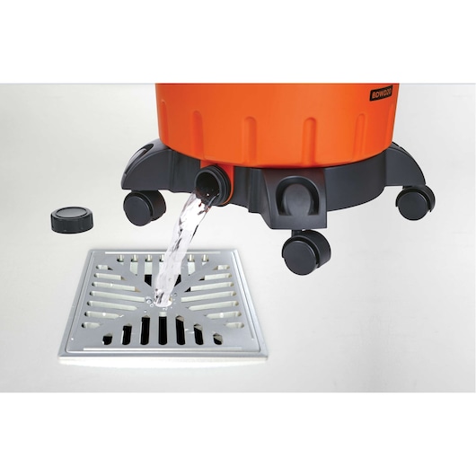 BLACKDECKER BDWD15 wet and dry vacuum cleaner base draining water into metal floor drain, side angle.