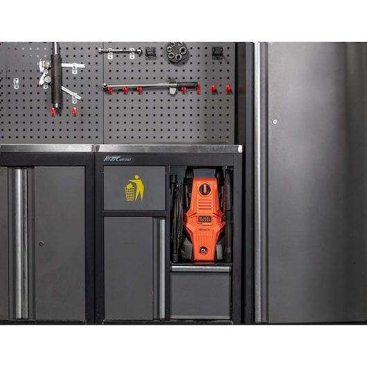 Photo of BLACKDECKER BEPWB1740 pressure washer stored in a metal cabinet with tools on a pegboard wall.