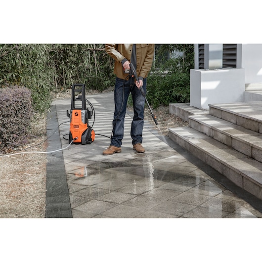 BLACKDECKER BEPWB2000 pressure washer in use cleaning outdoor tile pavement.