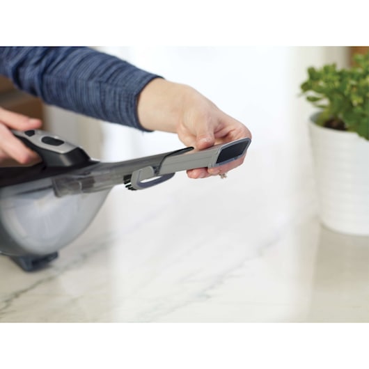 Photo of BLACKDECKER HLVA320J00 handheld vacuum with a closeup of the nozzle attachment on a countertop.