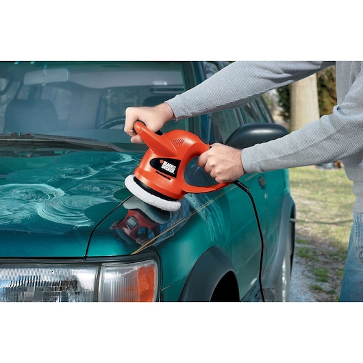 Photo of BLACK+DECKER WP900 car polisher in use on a green vehicle hood.